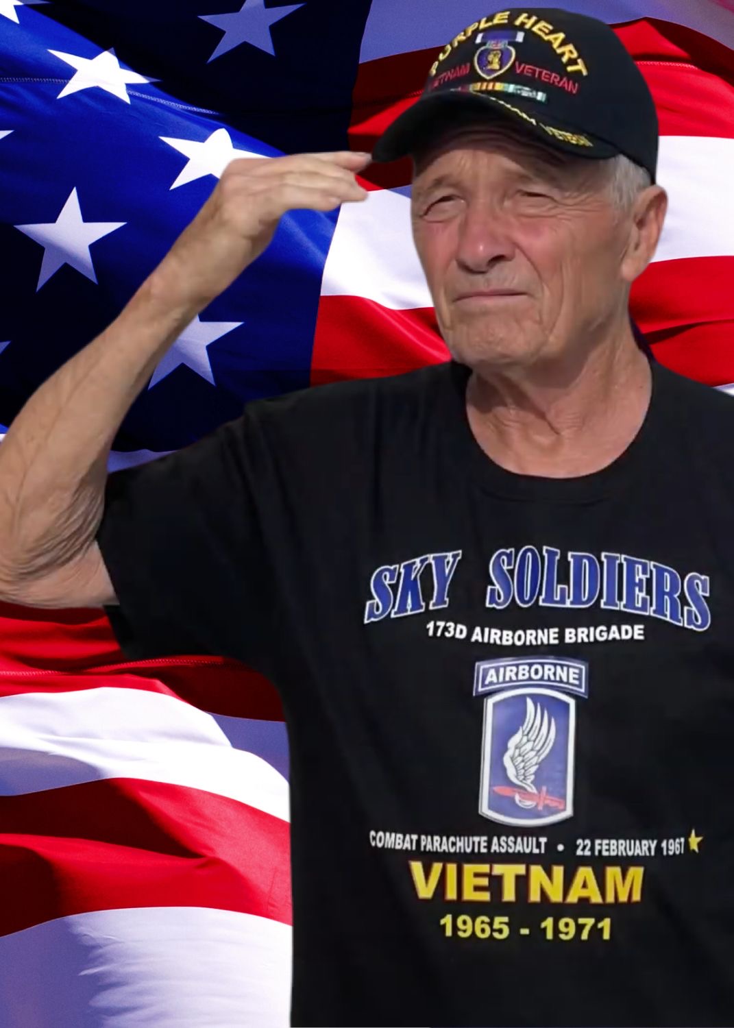 Joseph Mescan saluting in front of an American flag